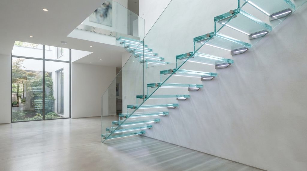 Glass staircase with concealed LED lighting and modern railing
